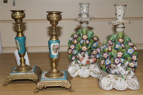 A pair of brass mounted Continental porcelain candlesticks, 7in. and a pair of porcelain candlesticks, 7.25in.